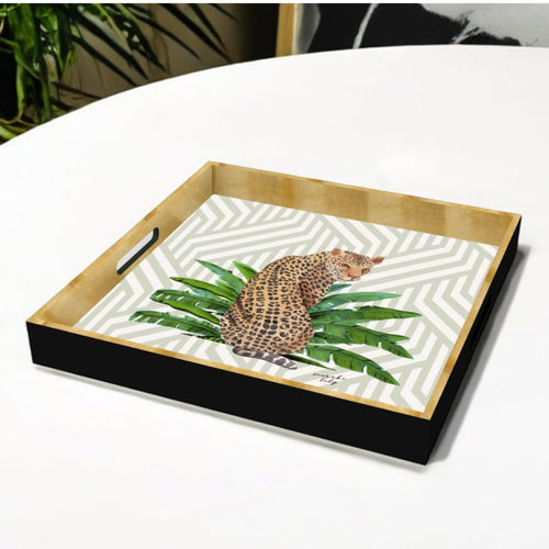 black and gold leopard tray on geometric background, bold and wild